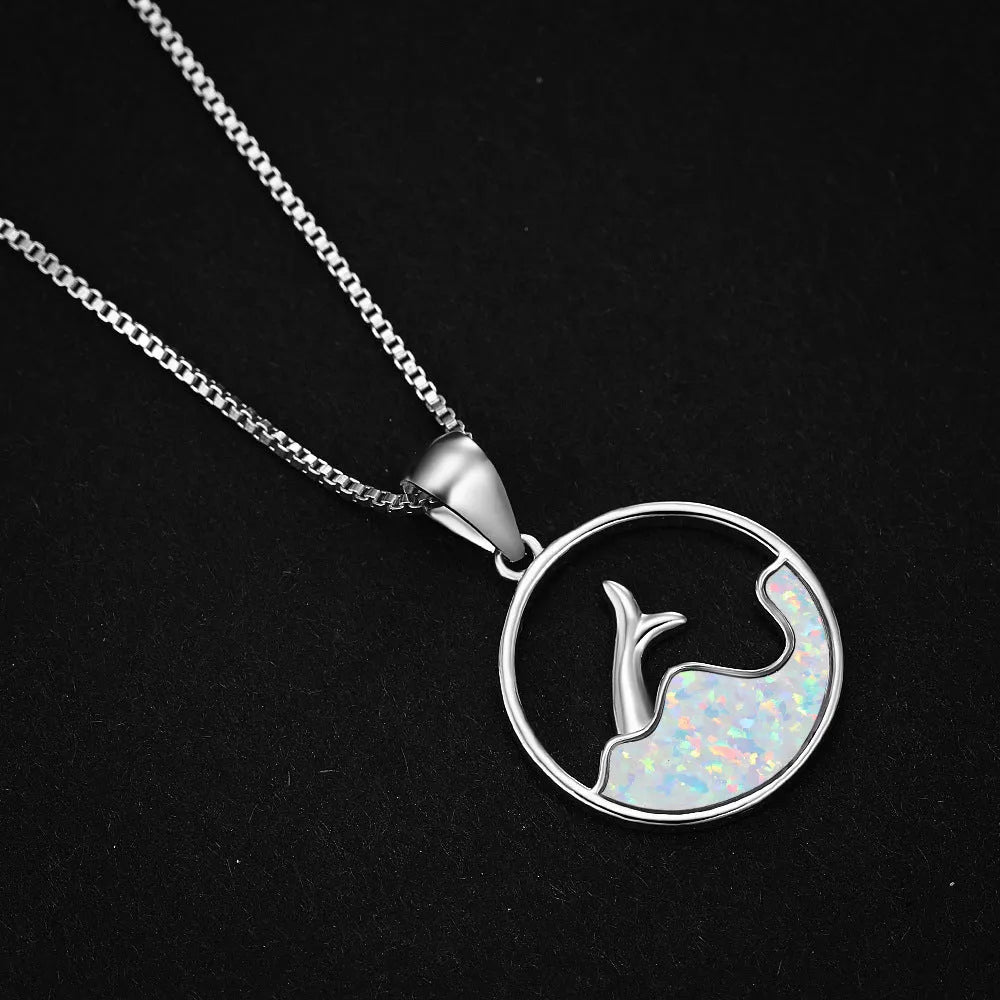 White gold electroplated copper necklace with a geometric sea fishtail pendant in a blue opal tone.