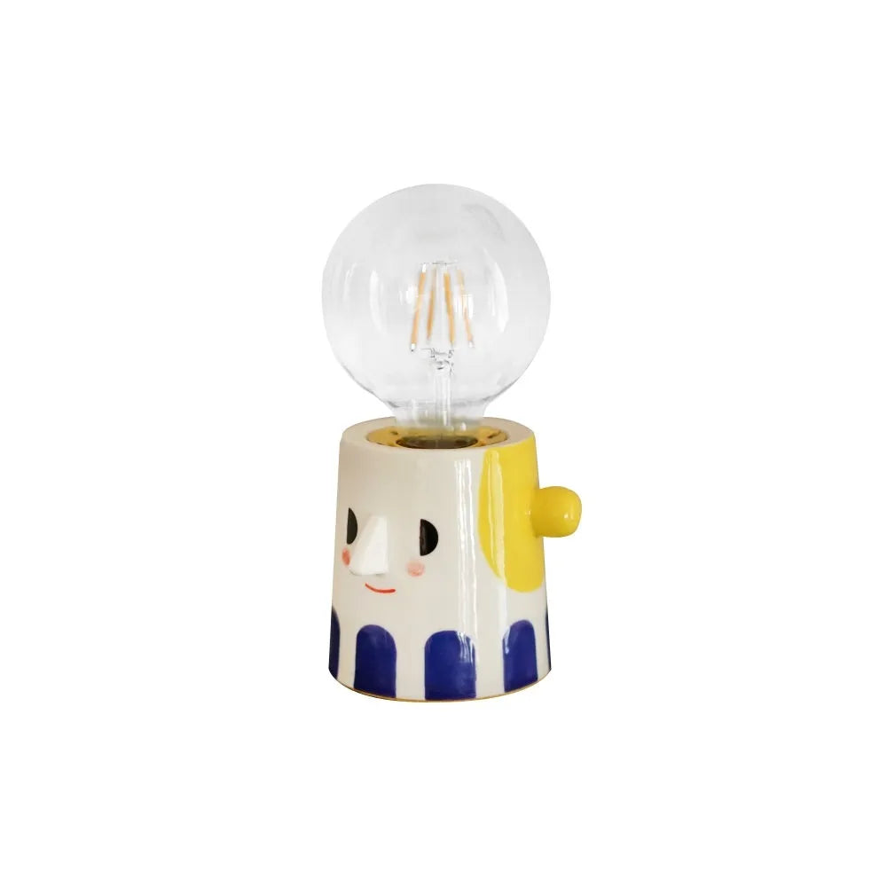 Handmade ceramic bedside lamp with ball headlight shade on wooden surface