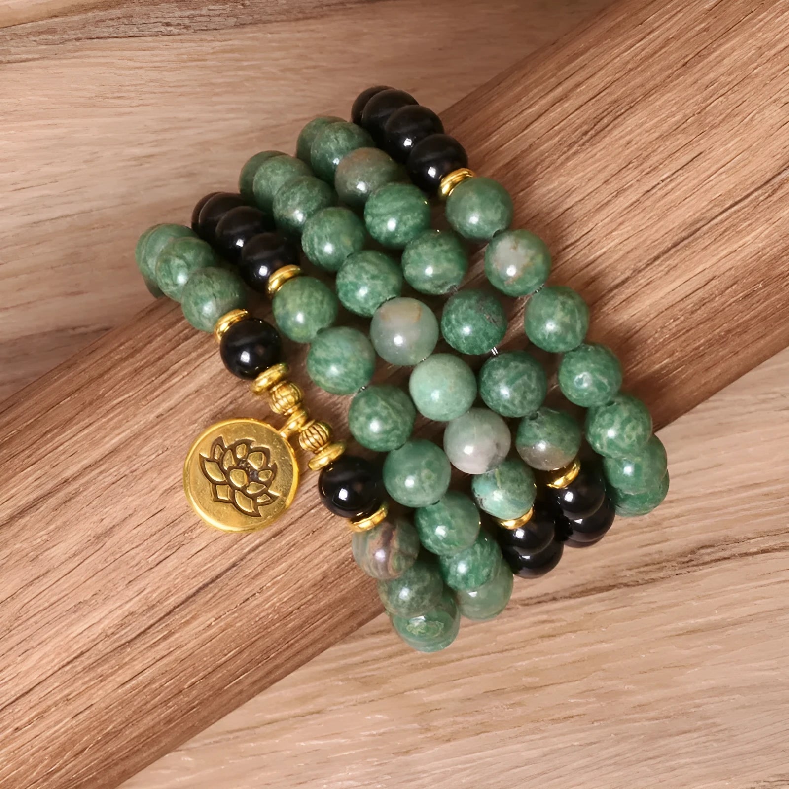 Green and black elastic beaded long bracelet with alloy construction shown on wrist