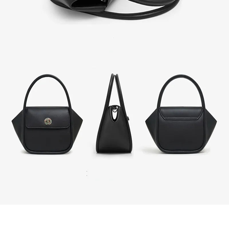 Brown leather wing-shaped tote bag with a buckle detail and latch closure, shown with a single cross-body strap.
