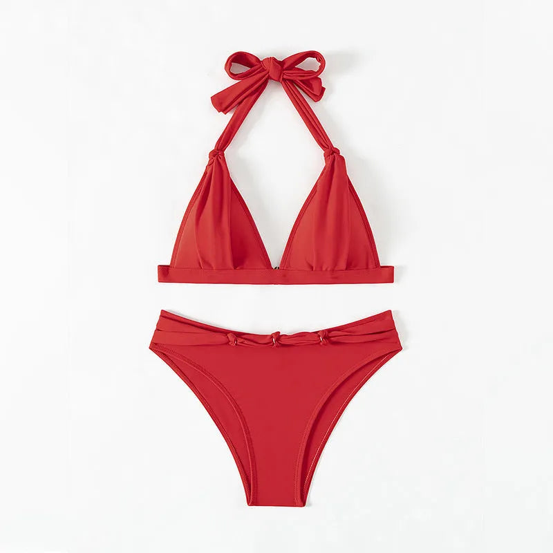 Red women's lace-up halterneck bikini set with separate shorts on a white background
