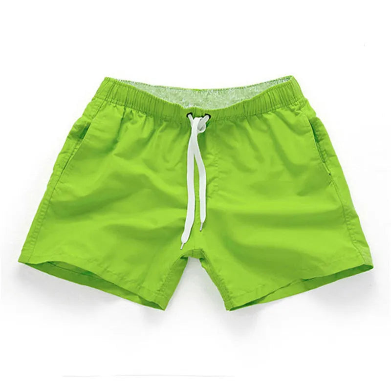 Men's straight-leg polyester beach shorts in black, shown on a model, highlighting the distressed finish and casual fit.