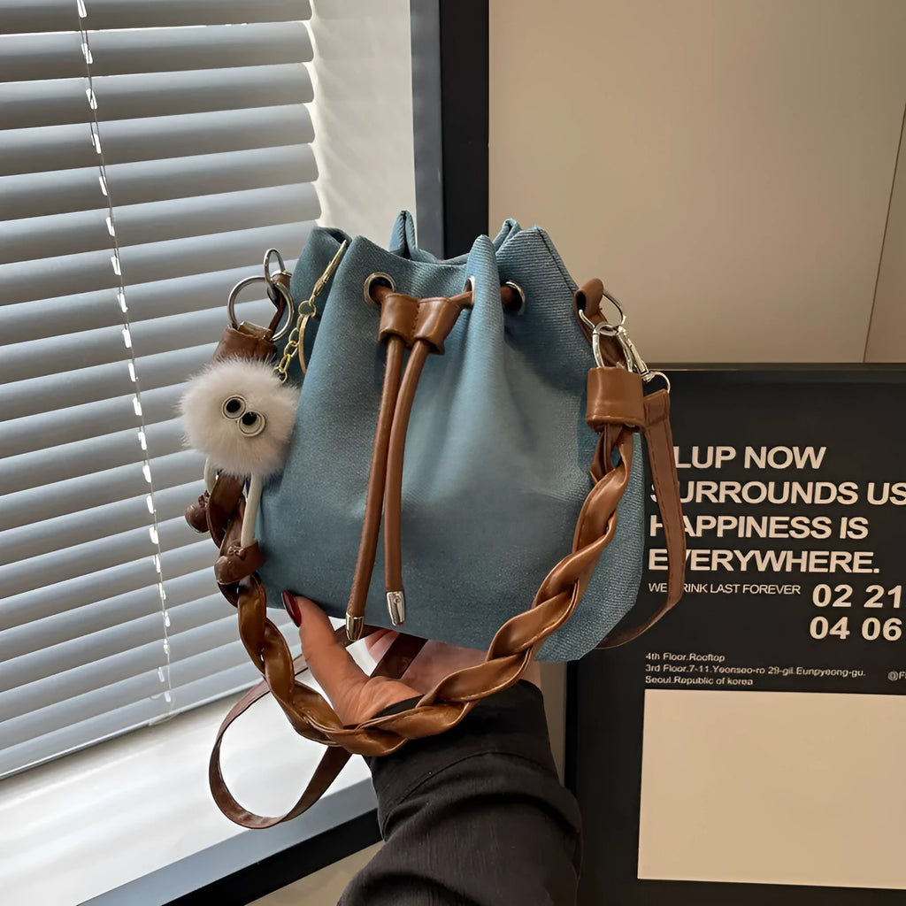 Blue synthetic leather cross body bucket bag with sandwich pocket construction