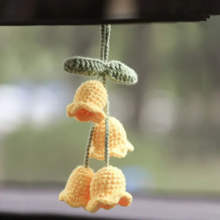 Green and white fish-scale style knitted wool car hanging planter with 8cm base and long white cord.