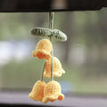 Green and white fish-scale style knitted wool car hanging planter with 8cm base and long white cord.