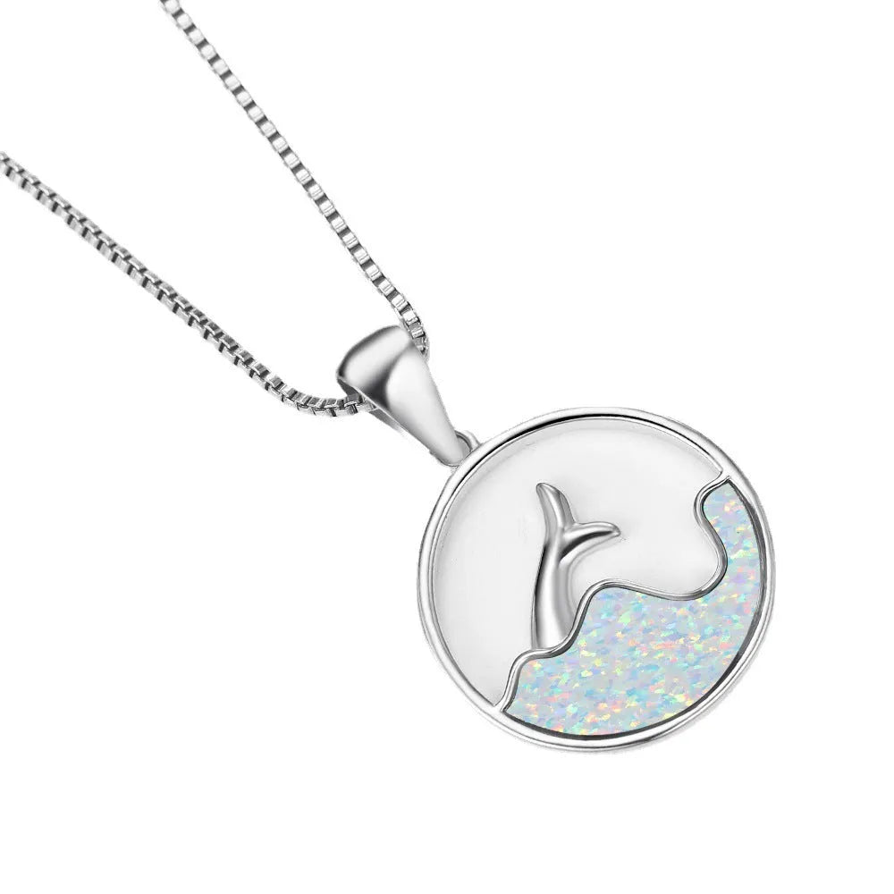 White gold electroplated copper necklace with a geometric sea fishtail pendant in a blue opal tone.