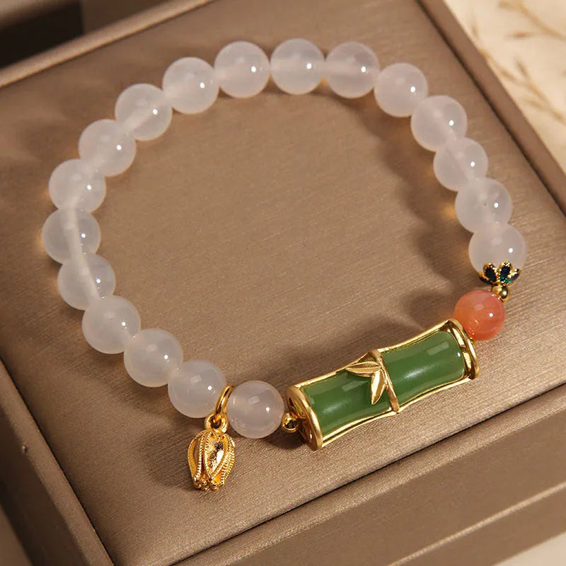 White agate and jade bamboo beaded bracelet with jasper accents on a neutral background.