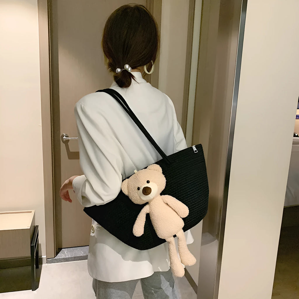 Woven cotton linen shoulder bag in dumpling shape with double straps and three-dimensional pocket.
