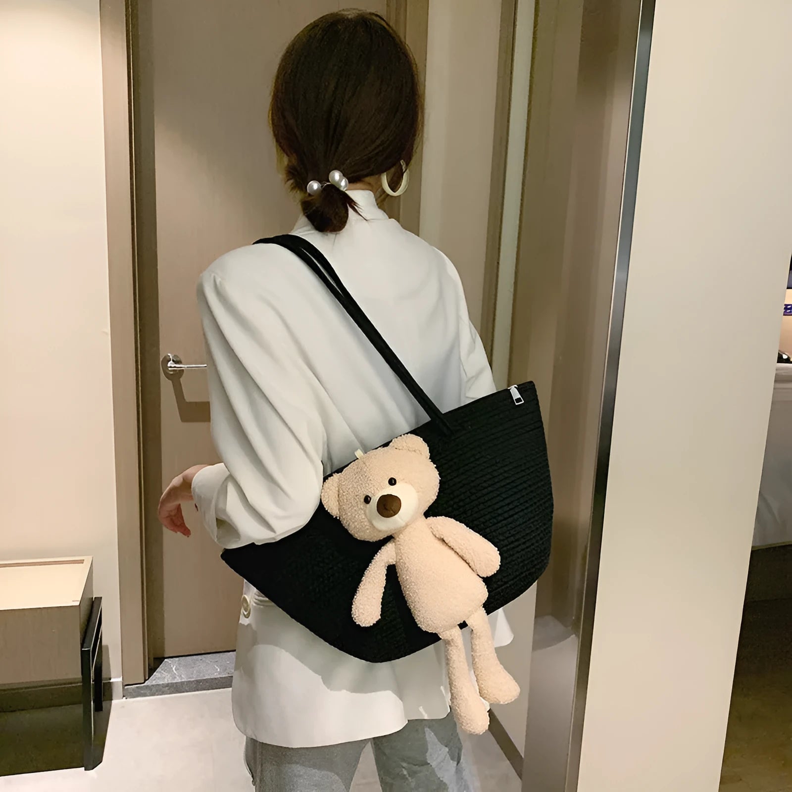 Woven cotton linen shoulder bag in dumpling shape with double straps and three-dimensional pocket.