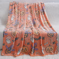 Cartoon print flannel blanket for children shown in two sizes on a bed.