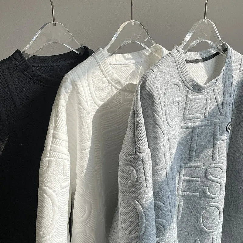 Men's grey short sleeve T-shirt with a raised 3D letter pattern, shown in a loose retro fit.