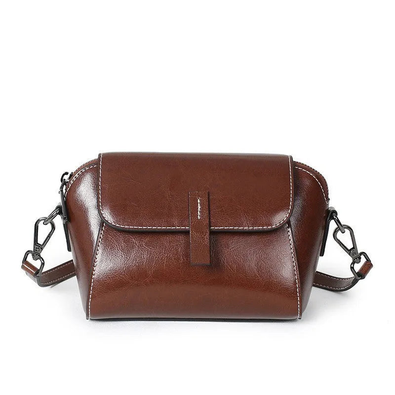 Women's brown oil wax cowhide leather messenger bag with cross-body strap and internal compartments
