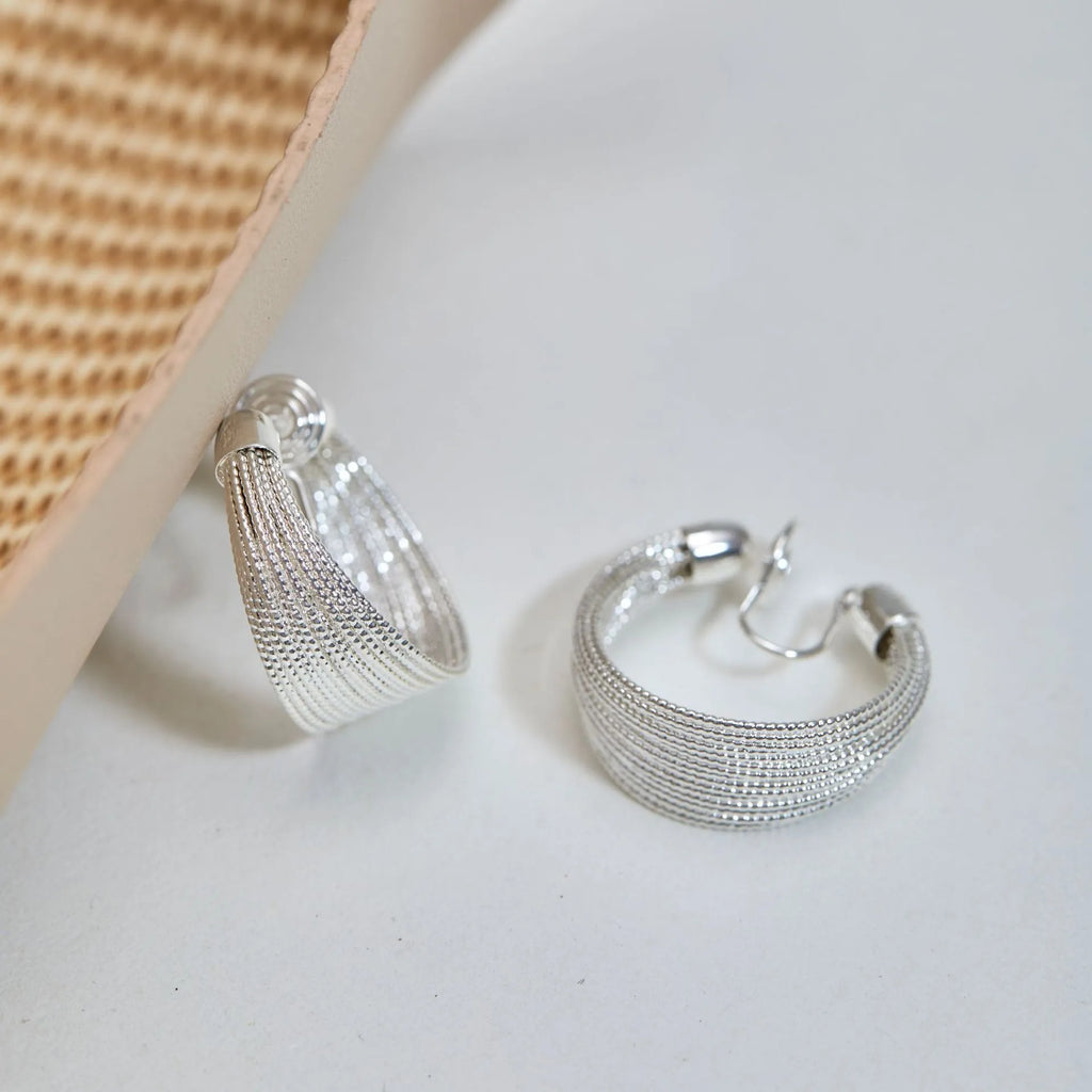 Simple geometric bracelet earrings with clip and stud backs in silver or gold colour.