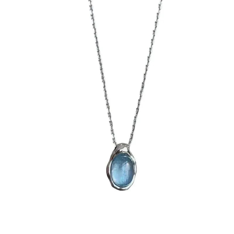 Navy blue water drop necklace with geometric design on adjustable cross chain