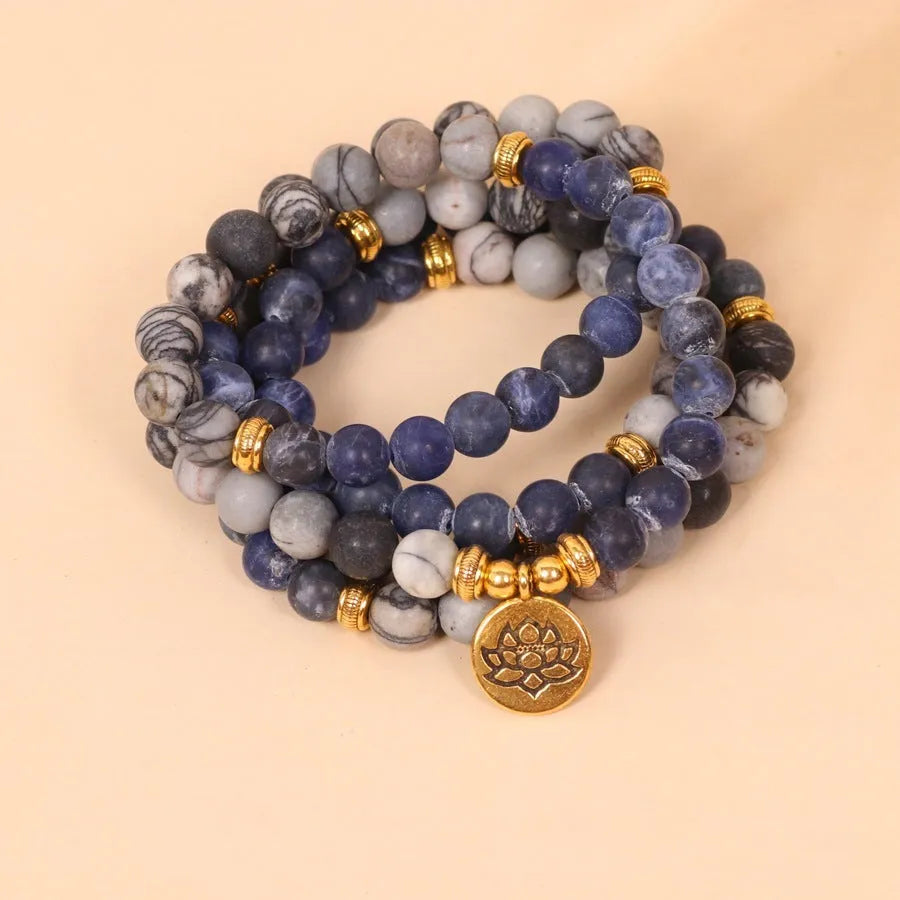Blue multi-layer alloy bracelet with patterned network stone beads.
