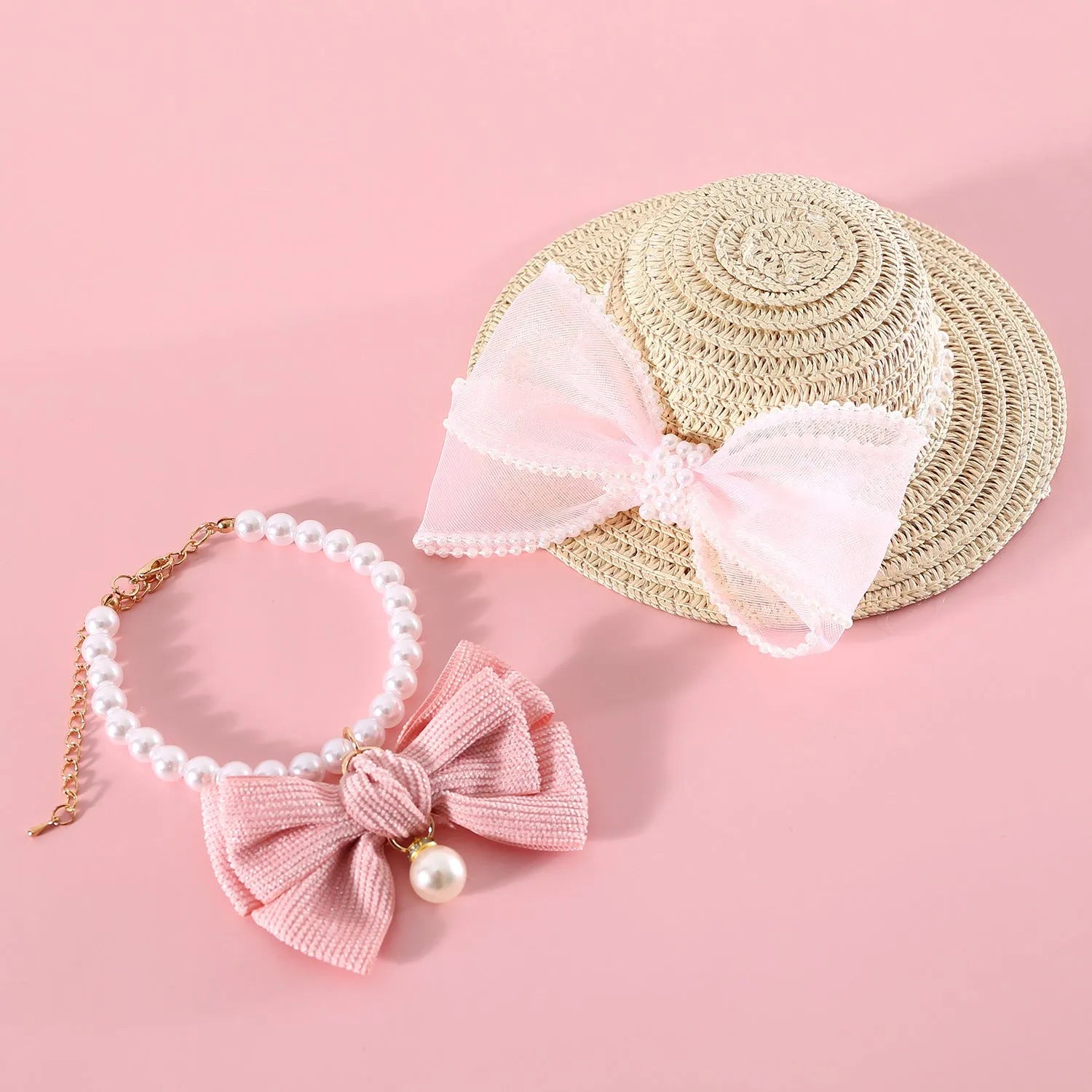 Pink pearl bow woven straw hat for a cat, shown in size S (13cm) on a mannequin head.