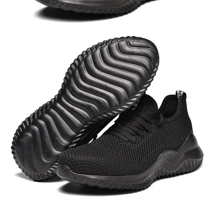 A pair of low-cut safety shoes with a steel toe cap, shown in a dark green colour option.