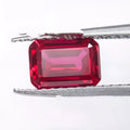 A loose, faceted artificial ruby gemstone in a deep pigeon blood red colour.