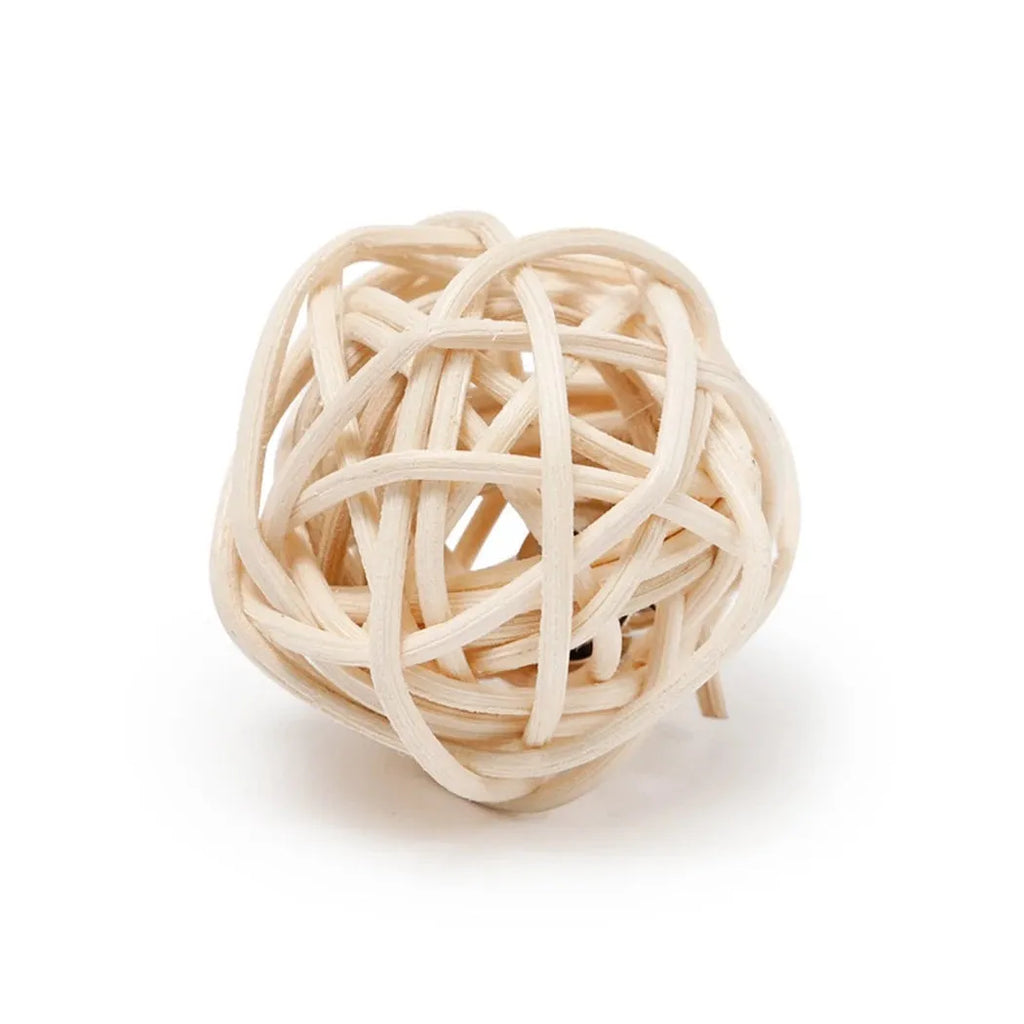 Two cat toys: hollow rattan ball and faux feather ball with bell on wooden floor