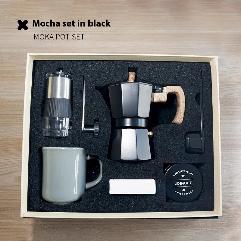 Six-piece manual grinding machine set in beige and black with moka pot, cup, bean jar, and accessories