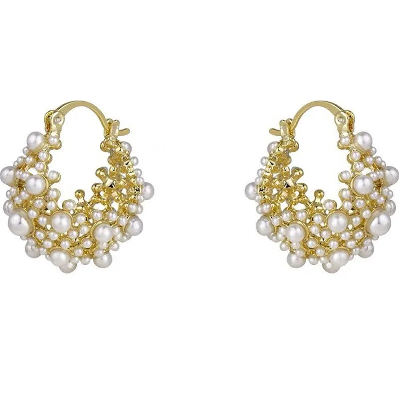 Gold tone copper flower basket earrings with small rice-shaped beads and a central pearl inlay.