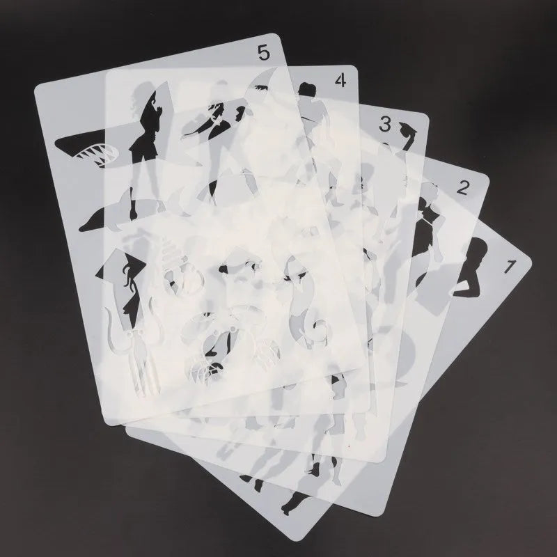 Set of white plastic drawing stencils with assorted cut-out patterns for crafts and decoration.