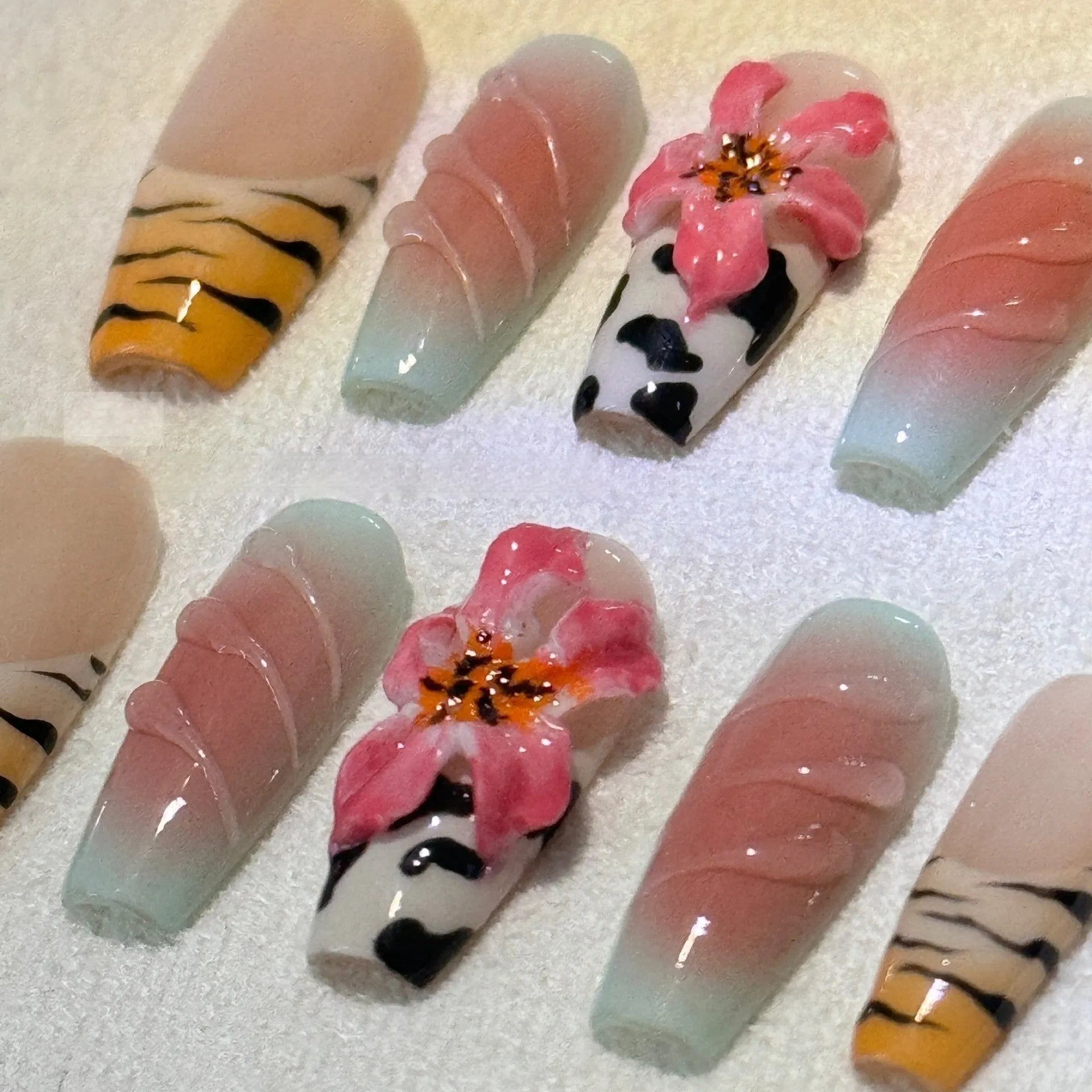 Hand carved false nails featuring a textured zebra pattern lily design in sizes XS, S, M, L.
