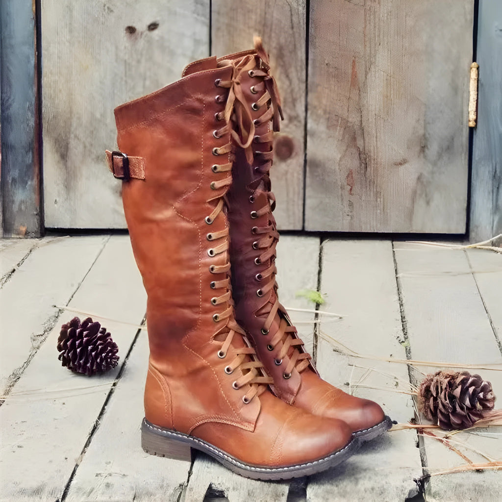 Women's black chunky heel high leg boots with a round toe and low block heel on a white background.