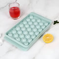Round blue silicone ice cube tray with lid showing 33 compartments