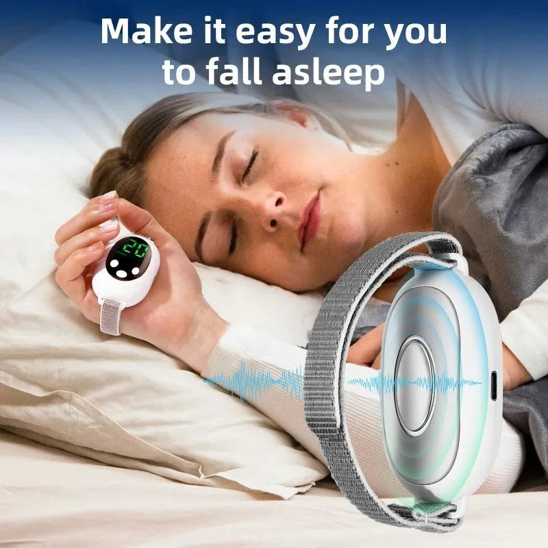 White handheld sleep aid remote control with digital display, charging cable, and wearable sleep bracelet on a flat surface.