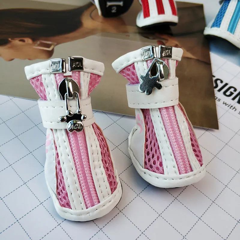 Set of four blue cloth dog shoes with zip closure and non-slip soles for pets.