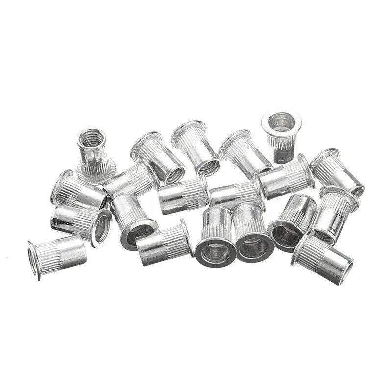 Alloy steel manual riveter nut tool set with spare rivet nuts on a workbench.