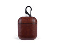 Genuine leather protective pouch for Apple Airpods charging case in black, brown, light brown, and red colours.