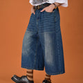 Men's straight-leg blue denim shorts with a loose fit and fifth pants length on a neutral background.
