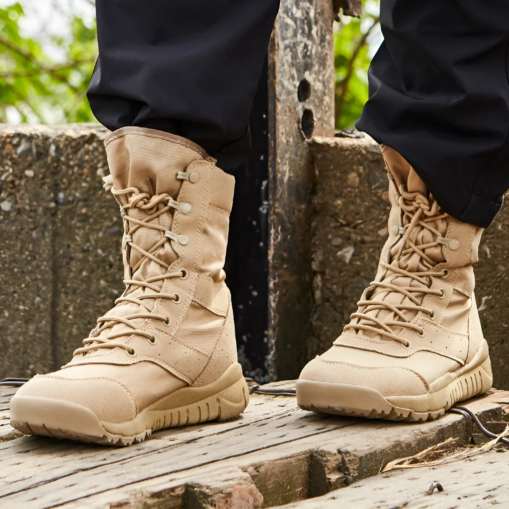 Yulong combat tactical desert boots in black and sand colour on a rocky outdoor background.