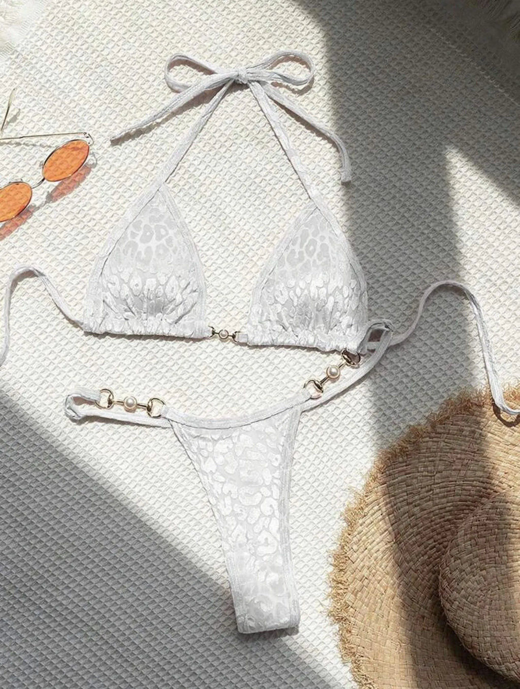 Women's T-shaped leopard print bikini swimsuit in polyester and spandex fabric on a mannequin.