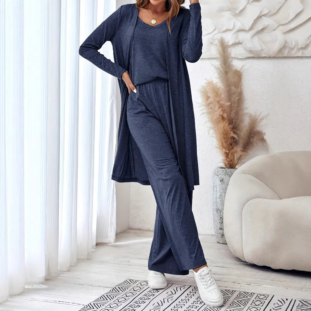 Blue women's three-piece co-ord suit with jumper top, long cardigan, and trousers with suspenders.