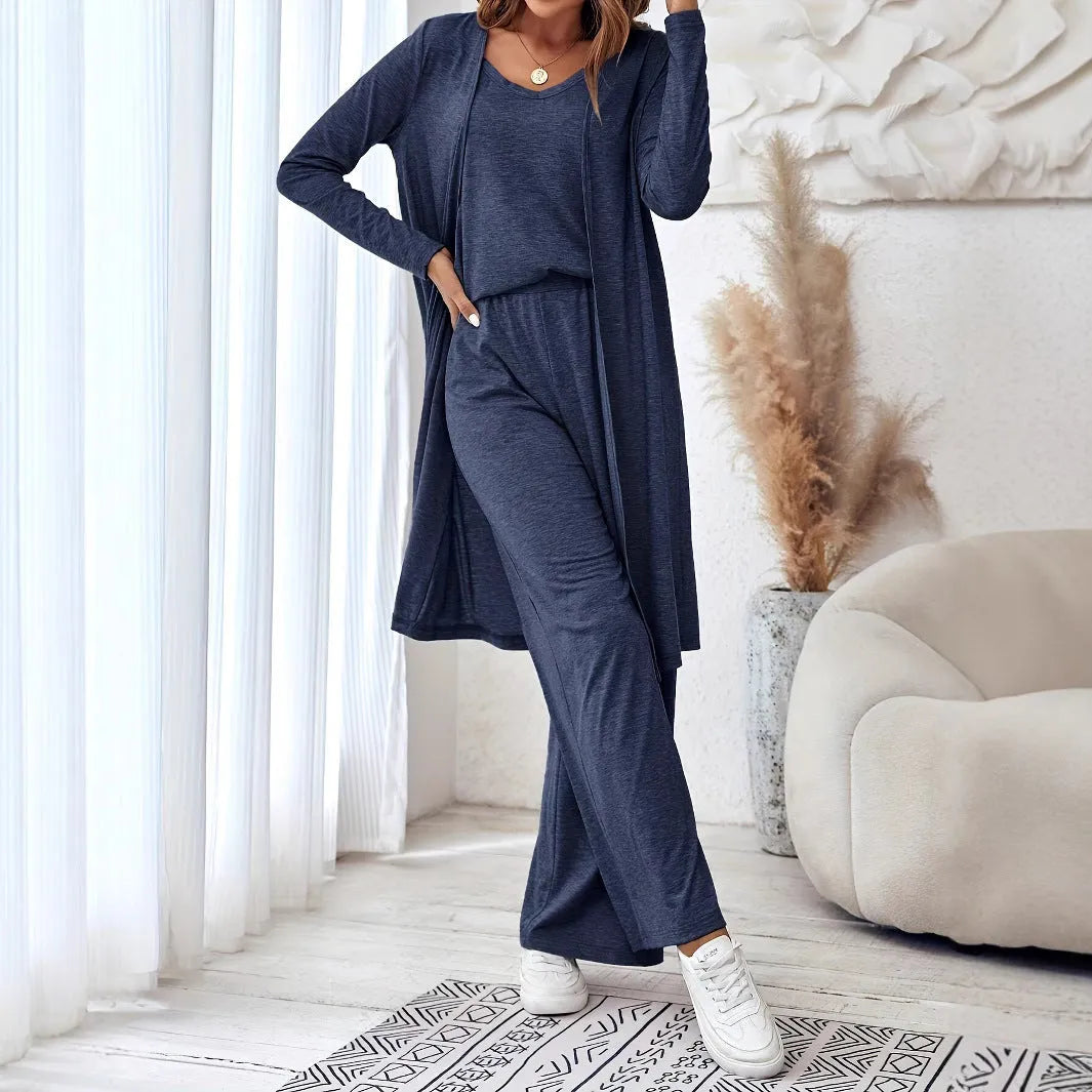 Blue women's three-piece co-ord suit with jumper top, long cardigan, and trousers with suspenders.