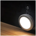 Circular white motion sensor LED light with 80mm diameter, shown mounted inside a wardrobe.
