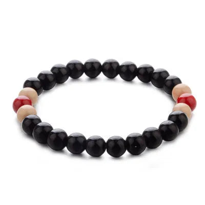 Natural lava stone beaded bracelet for men and women on a neutral background.