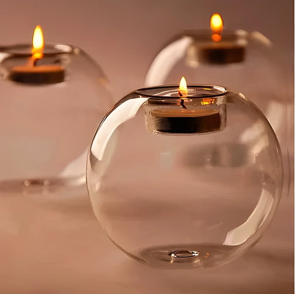 Handmade round hollow glass candle holder in clear glass on wooden surface