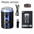 Black mini portable electric shaver with USB cable and cleaning brush on a white background.