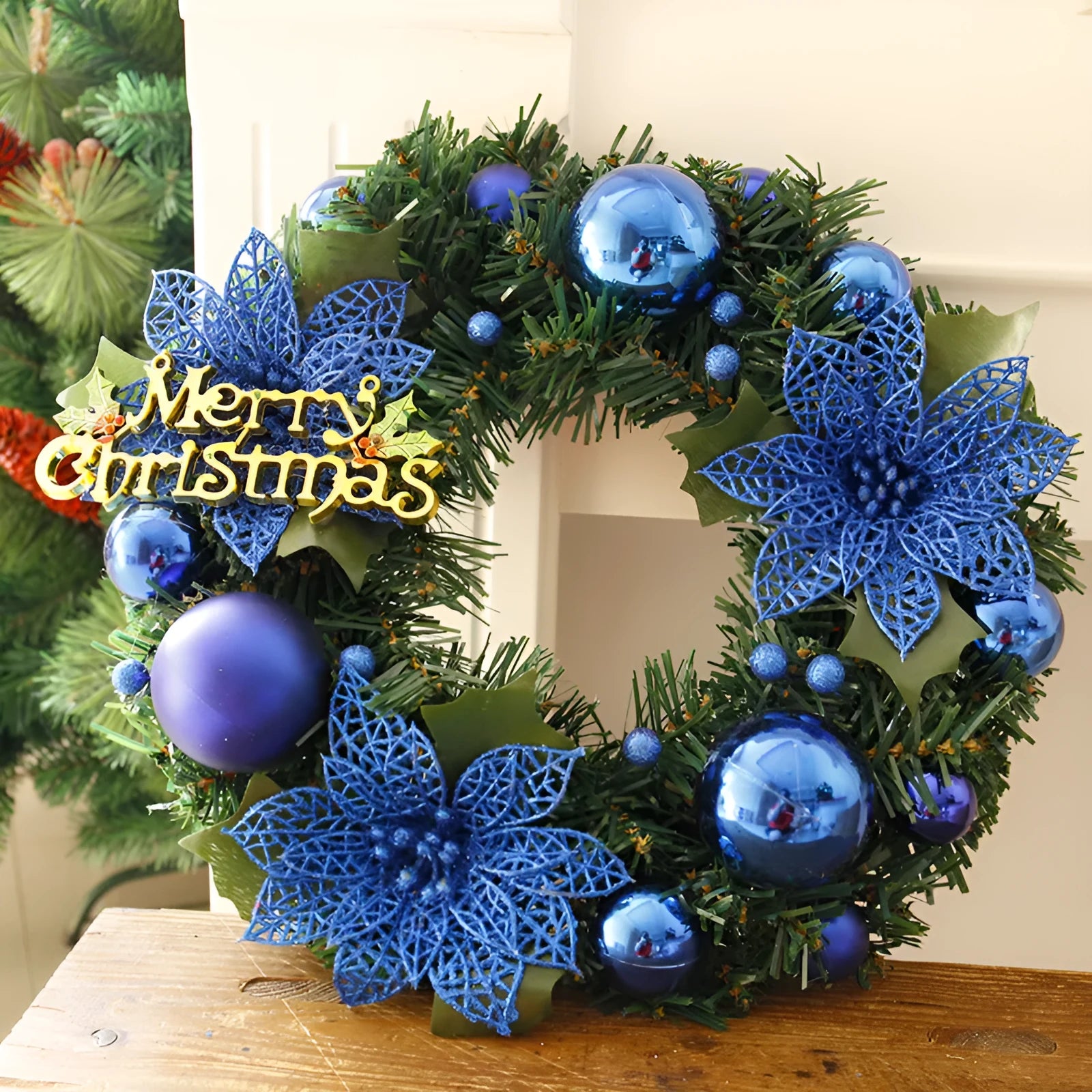 Multicolour plastic Christmas wreath with a 30cm diameter, hung on a door.