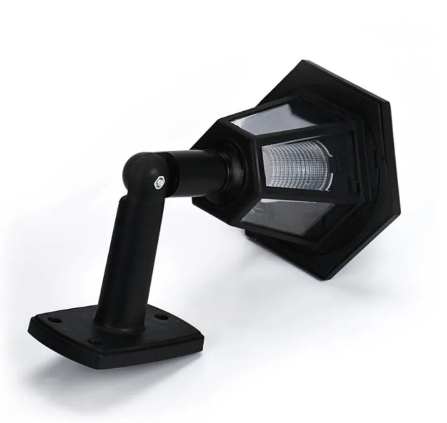 Black hexagonal solar-powered wall light with automatic sensor for outdoor garden or patio lighting