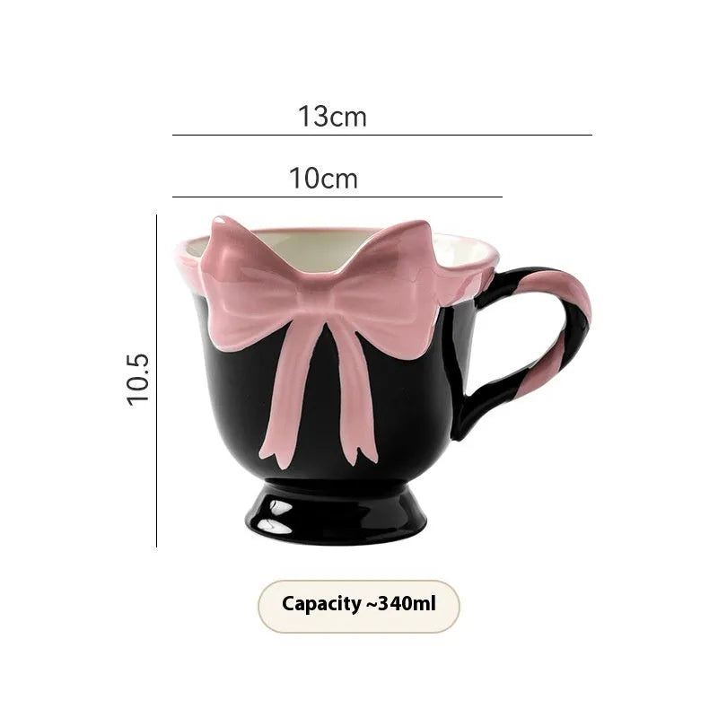 Ceramic mug with a decorative heart bow design in black pink or white powder colour.