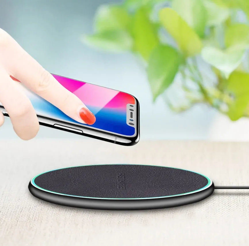 Black circular wireless charging pad for iPhone 11 with LED indicator light
