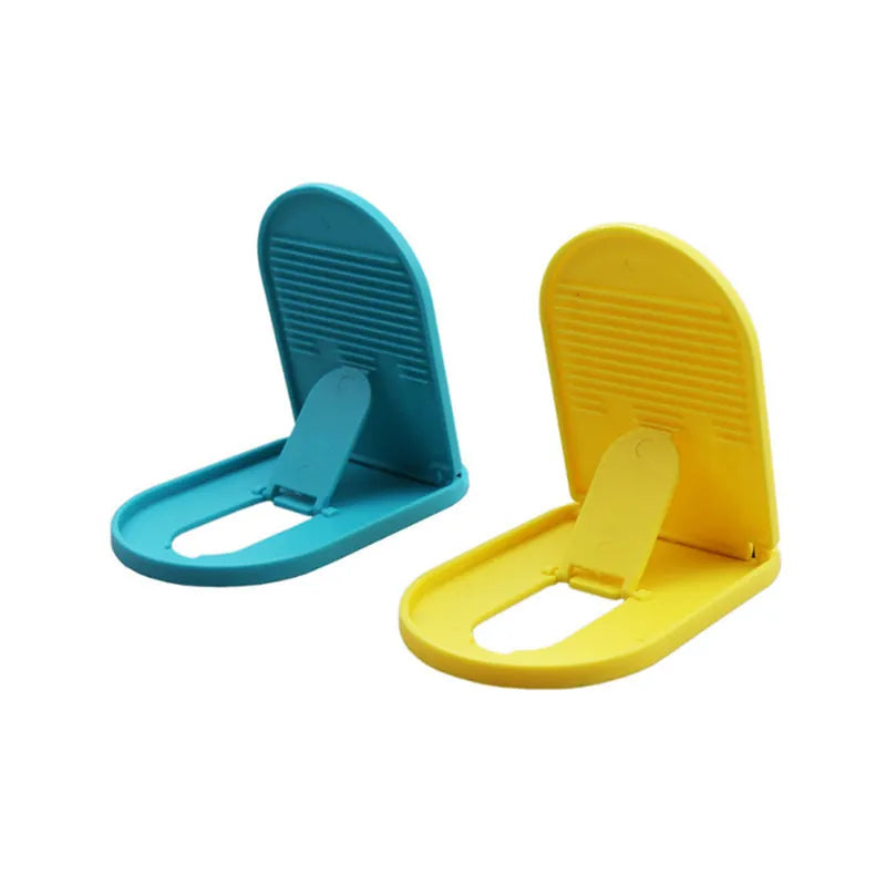 Plastic adjustable bracket mobile phone stand in six colour choices on a desk.