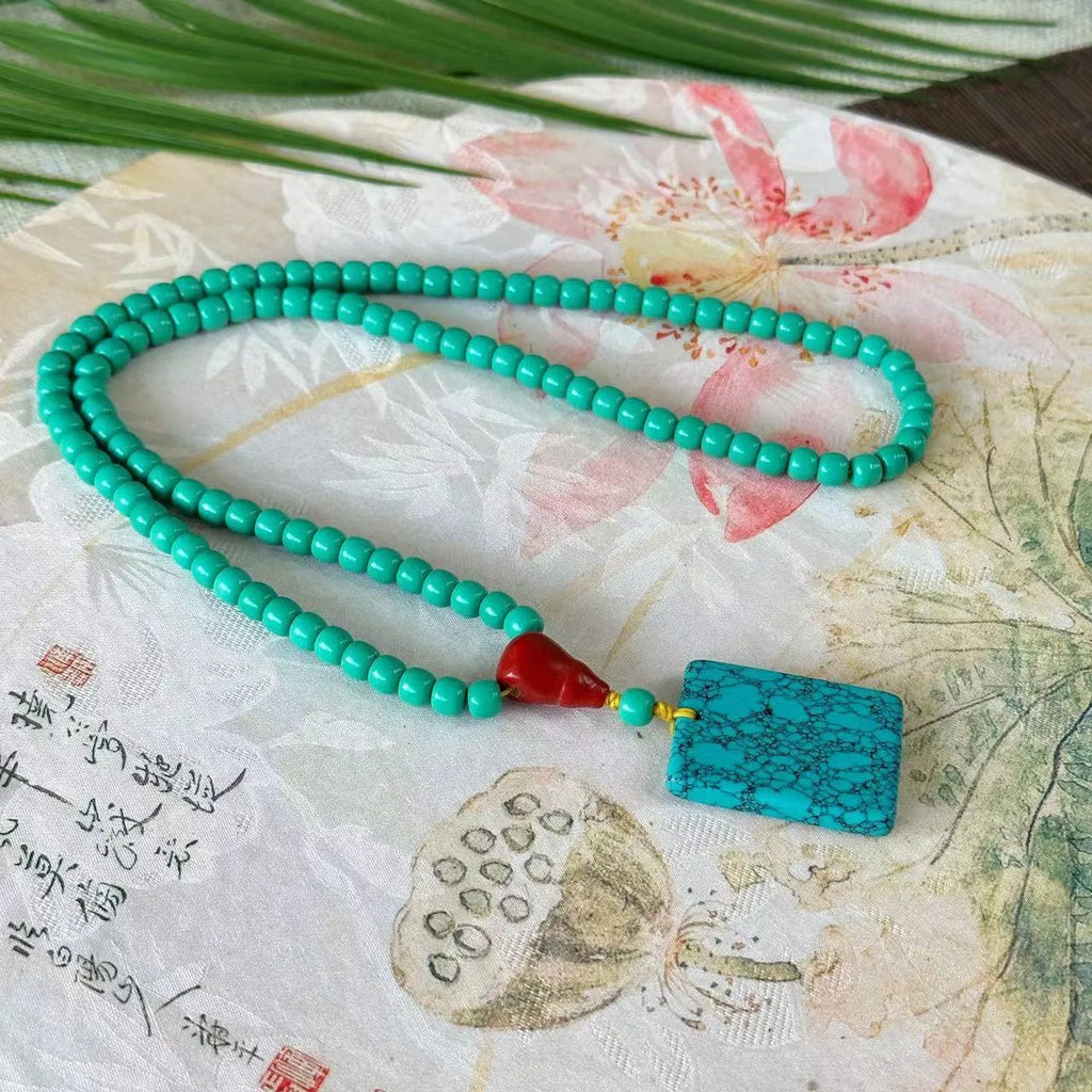 Turquoise stone pendant in hand-woven mesh flower setting on adjustable ball bead necklace chain