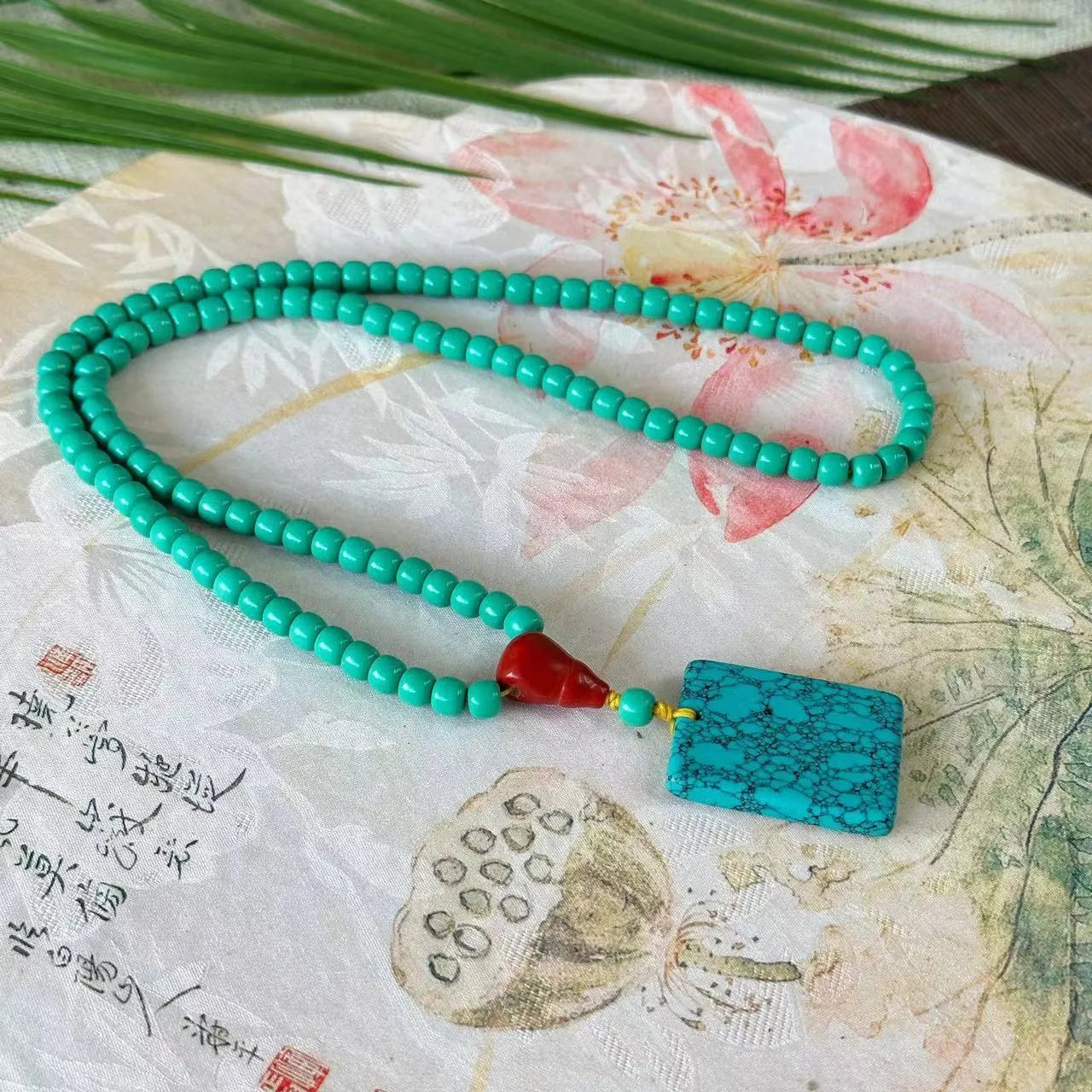 Turquoise stone pendant in hand-woven mesh flower setting on adjustable ball bead necklace chain