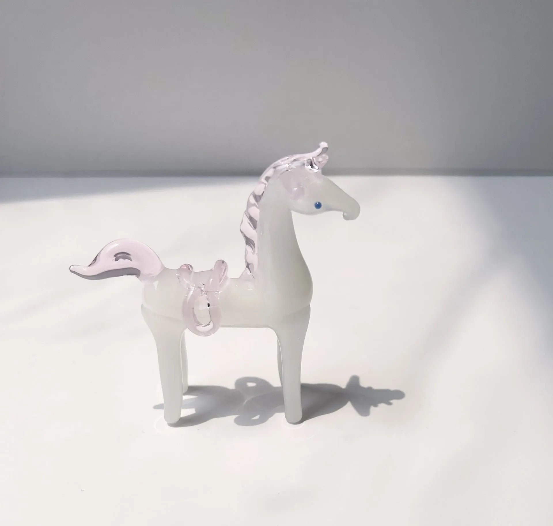 Glazed ceramic horse figurine decoration in modern simplicity style on a desk.
